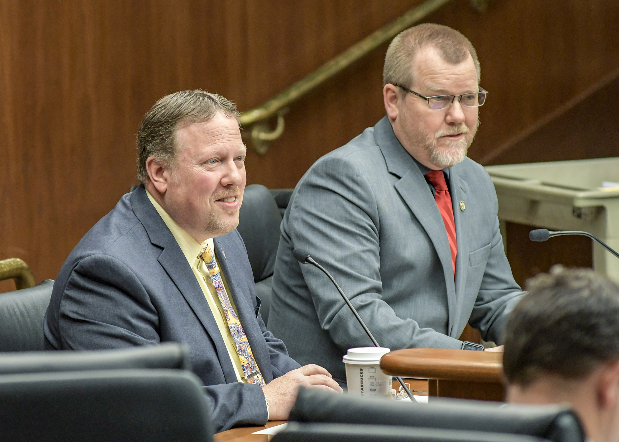 Steve Dennis, owner of Dennis Brother Liquors, testifies before the House Commerce Committee March 1 in support of a bill sponsored by Rep. Tony Jurgens, right, that would shift Sunday hours for liquor store operators. Photo by Andrew VonBank